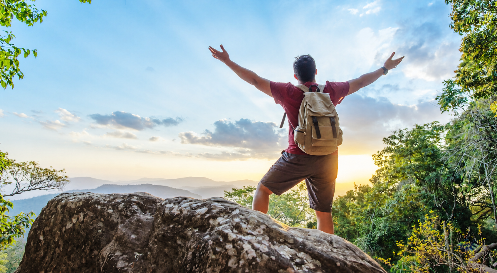 Traveller celebrating on a mountain viewpoint