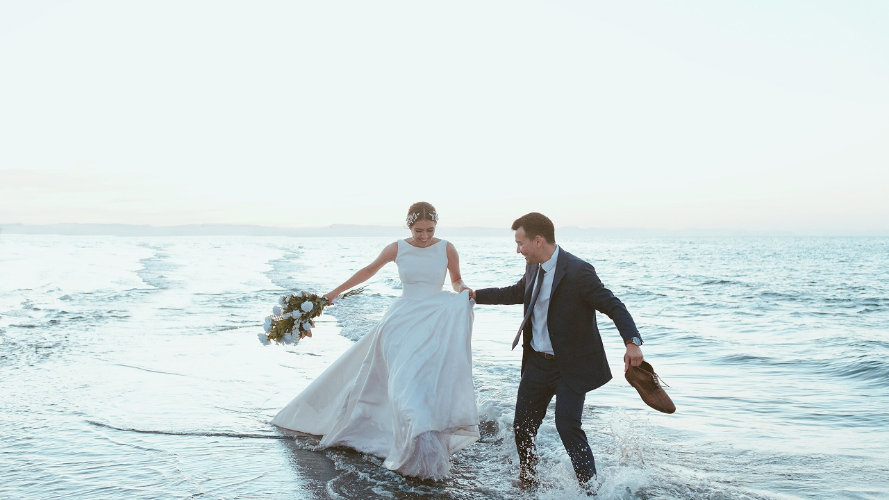 Couple celebrating beside the sea