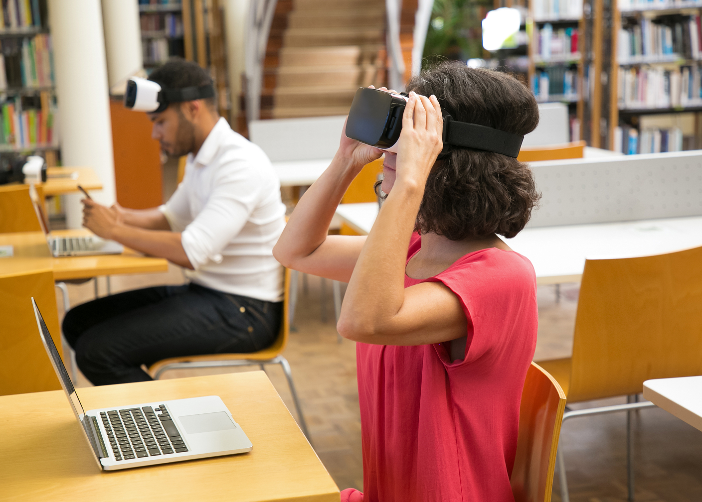 Student using a virtual reality headset in a library