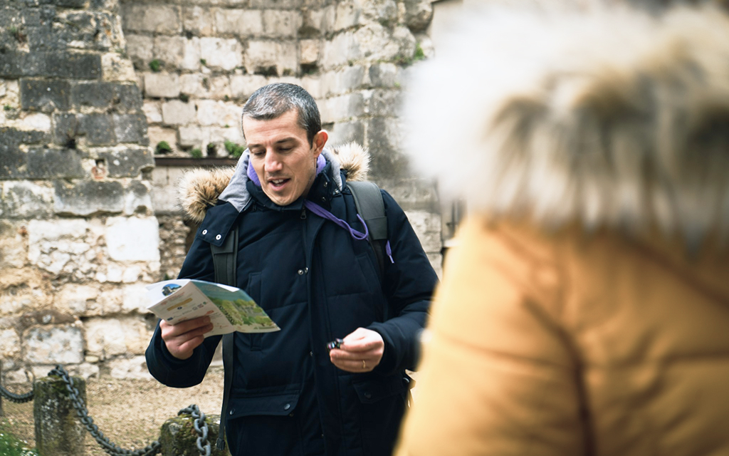 Local guide explaining a map to travellers